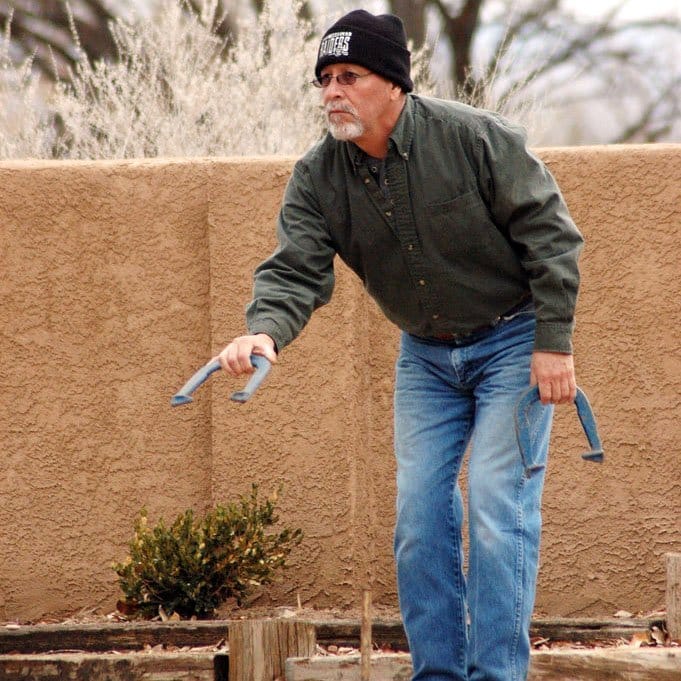 senior man playing horseshoe