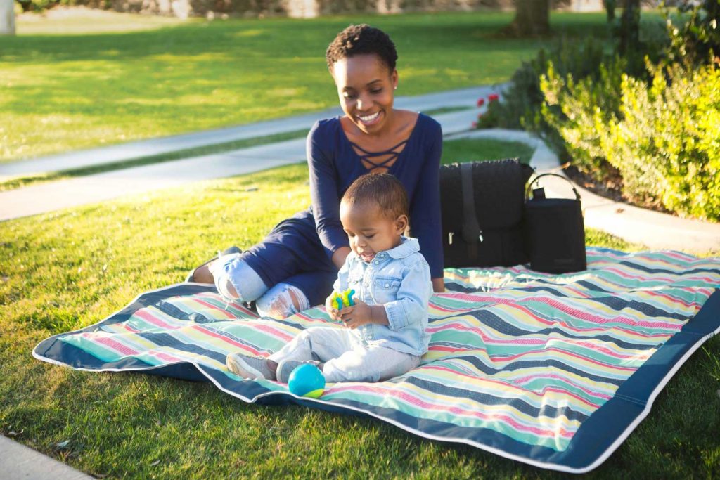 mother and baby laying on jj cole outdoor blanket