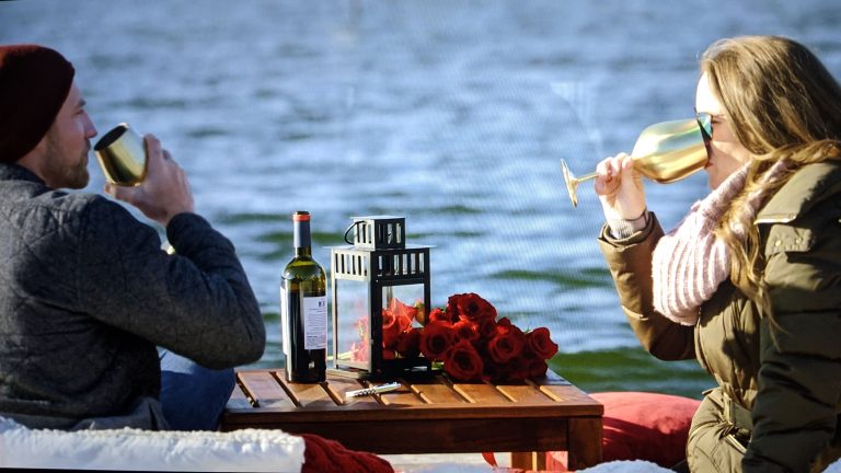 couple drinking wine from gold wine glasses