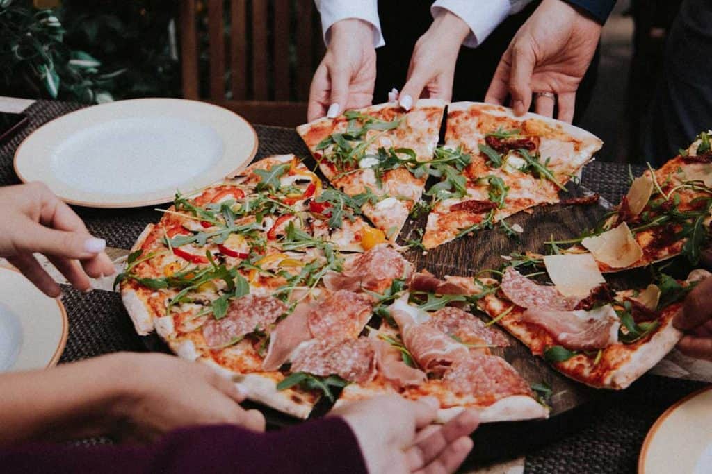 people sharing food at picnic