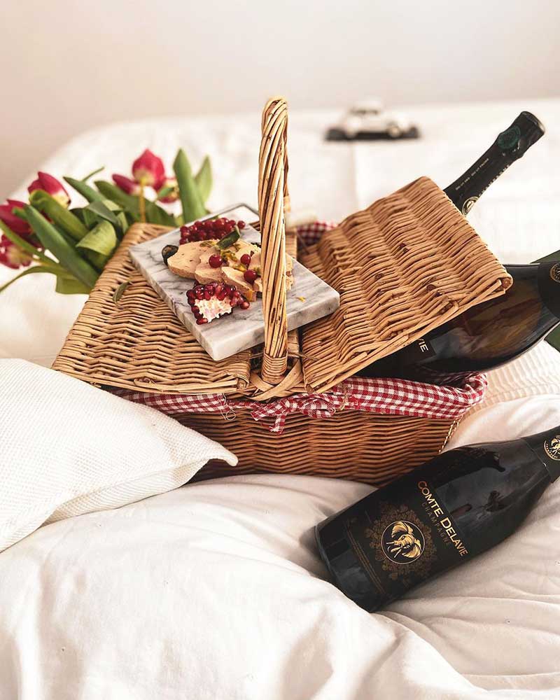 french wine bottles in a wicker basket