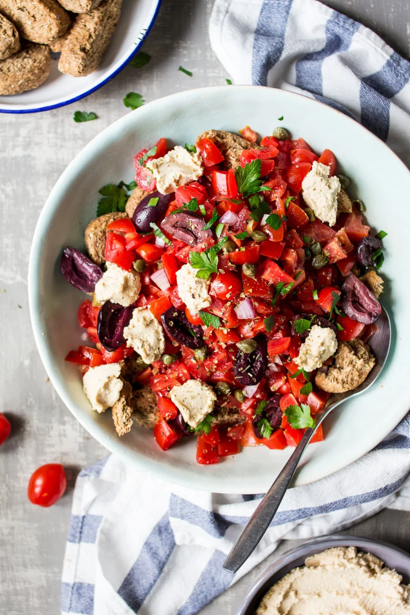 dakos vegan salad with olives in a bowl