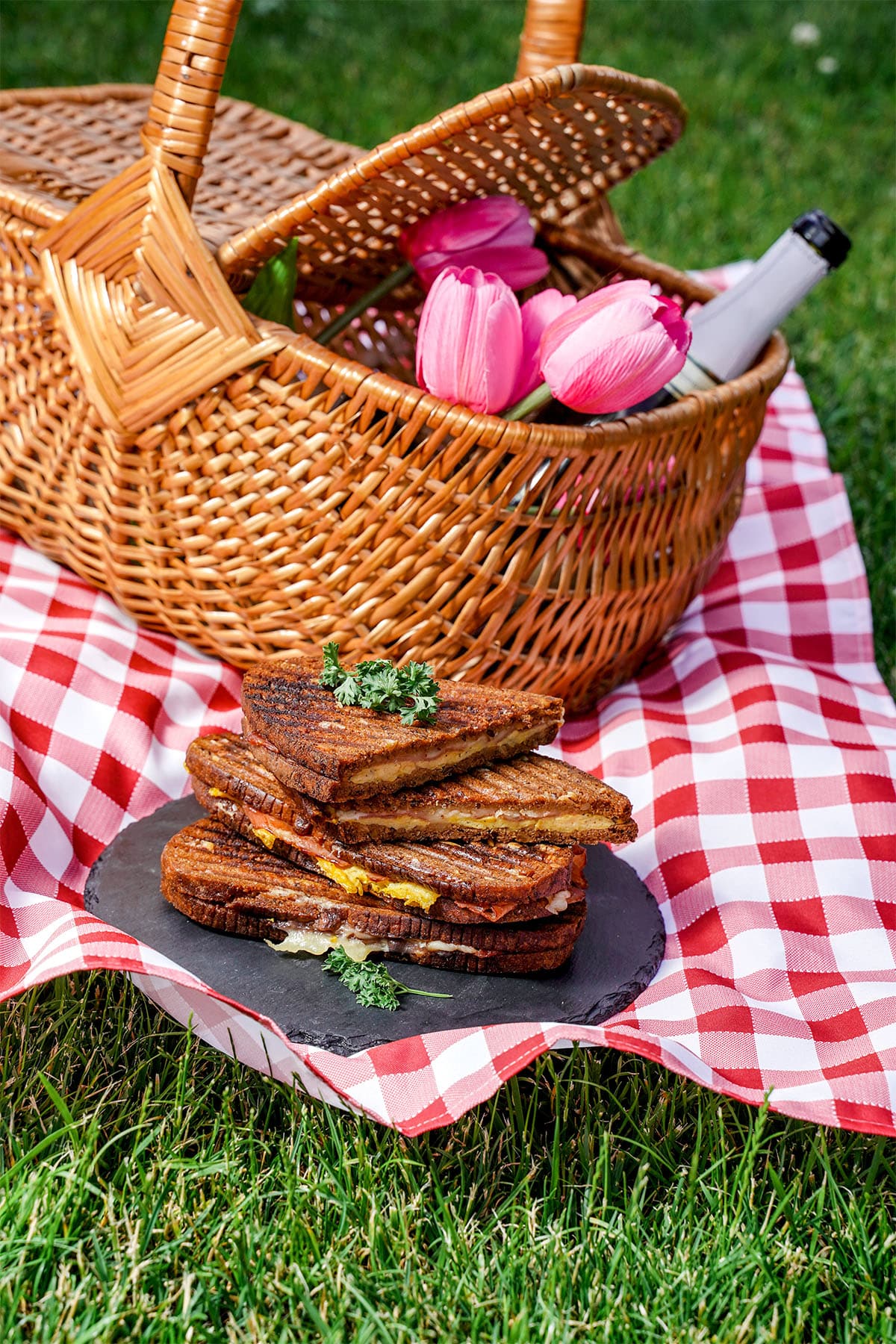 Bacon And Eggs Panini on a plate at a picnic