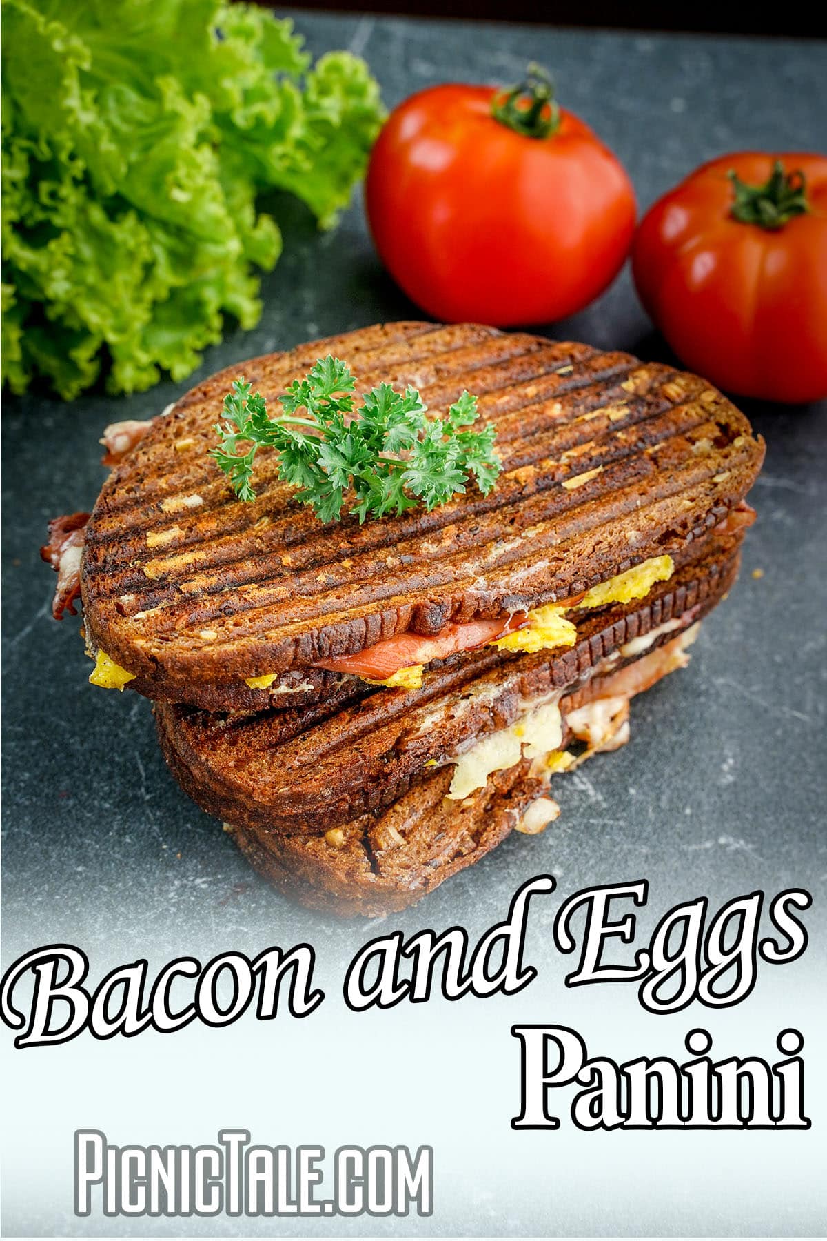picnic sandwich stacked with text which reads Bacon And Eggs Panini