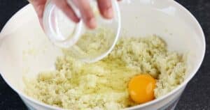 Adding egg to the Cauliflower in, Cauliflower Cheese Sandwich,