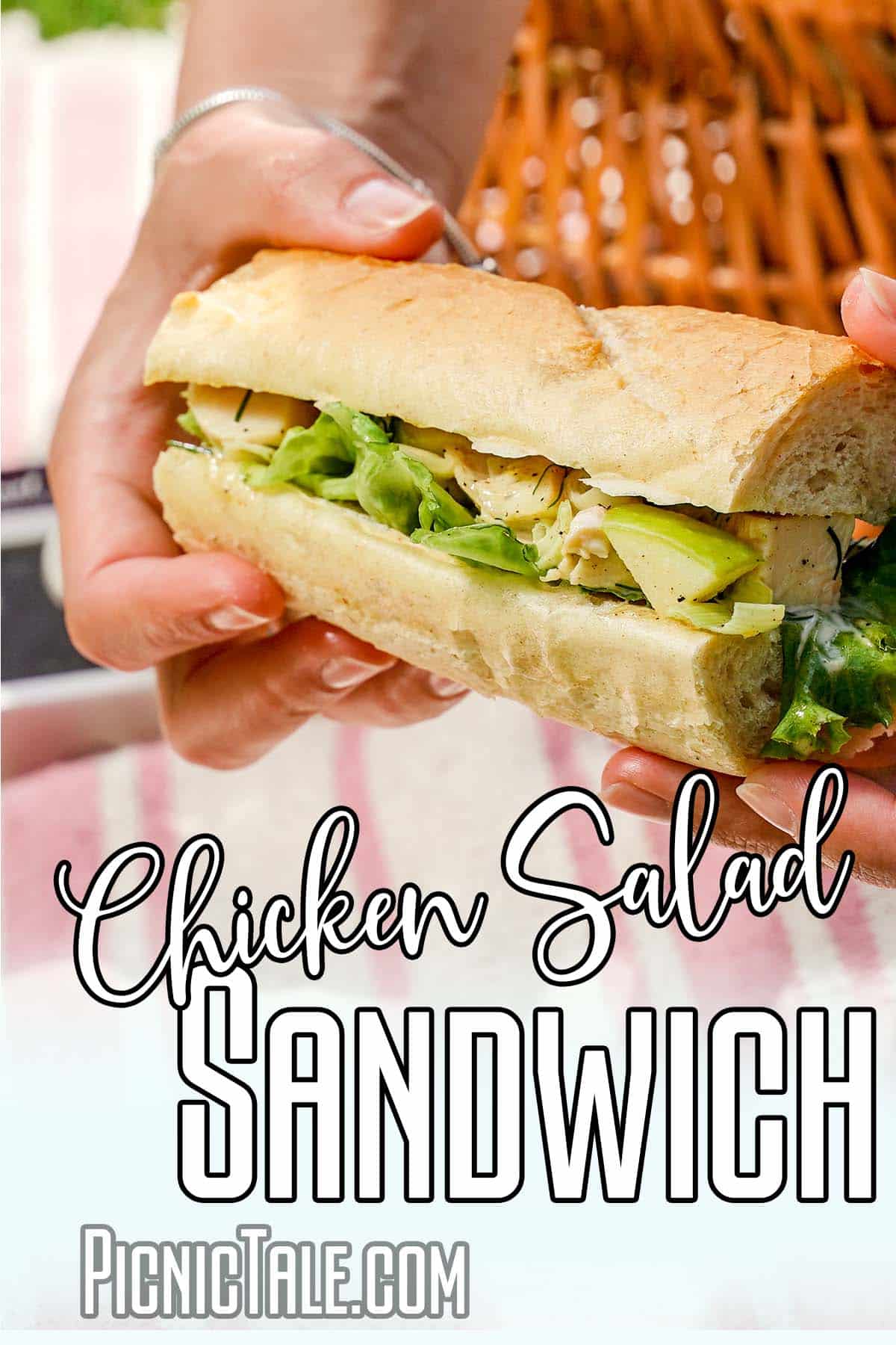 Holding Chicken Salad Sandwich, wording on bottom.