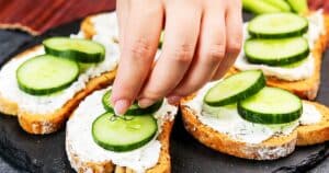 Adding Dill to Cucumber Dill Toast Sandwich.