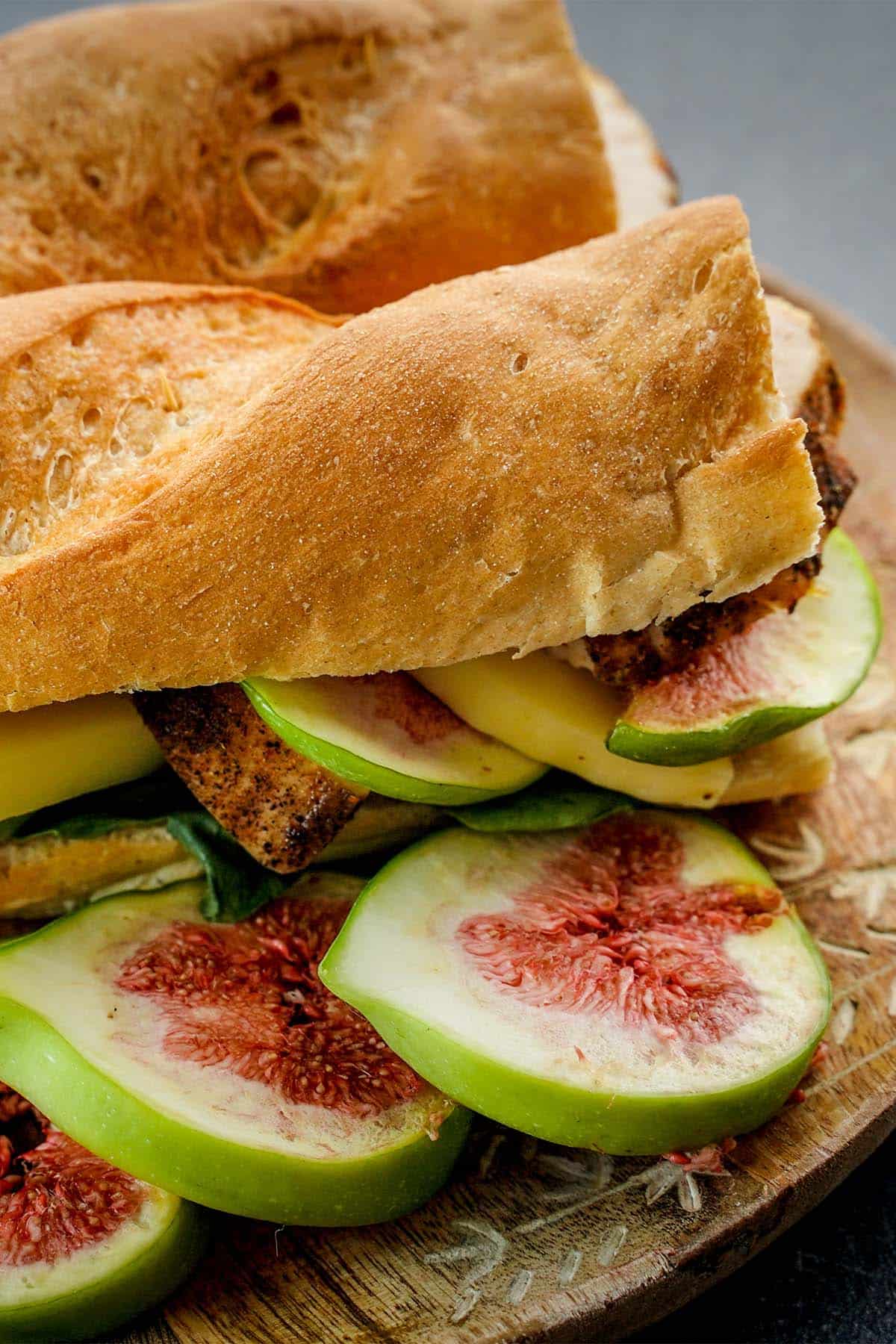Fig and Chicken Baguette Sandwich, side view fig slices on plate.