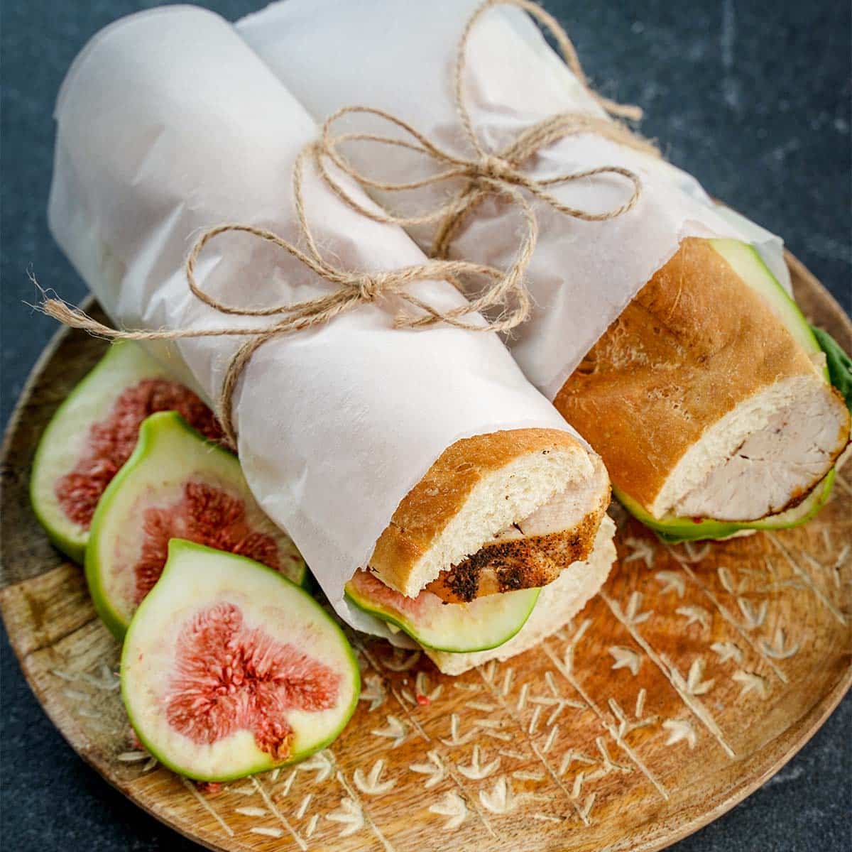 Wrapped in parchment paper, Fig and Chicken Baguette Sandwich.