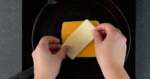 layering cheese to make Hawaiian Grilled Cheese sandwiches