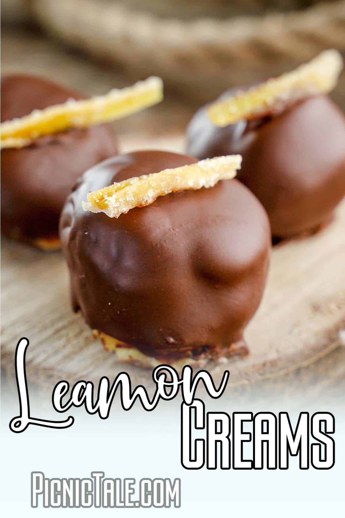 closeup of chocolate covered lemon cookies with text which reads Lemon Creams