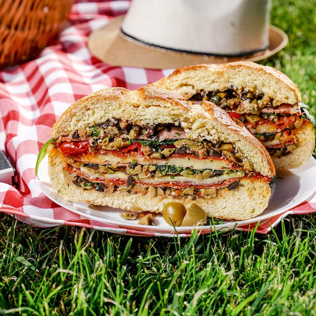 Muffaletta Sandwich outside grass in front.