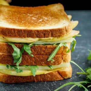 Close up of Pear Gouda Grilled Cheese. stacked by two.