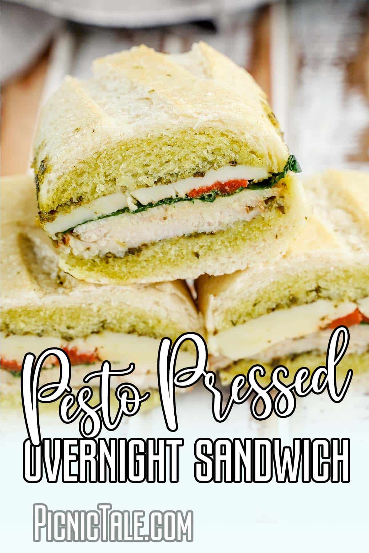 Three stacked Pesto overnight pressed sandwich, lettering on bottom.