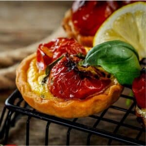 Roasted Tomato Pancetta Mini Quiches cooling on a rack