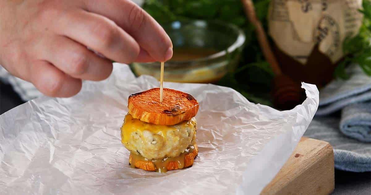 Adding toothpick to the Turkey Sliders with Sweet Potato.