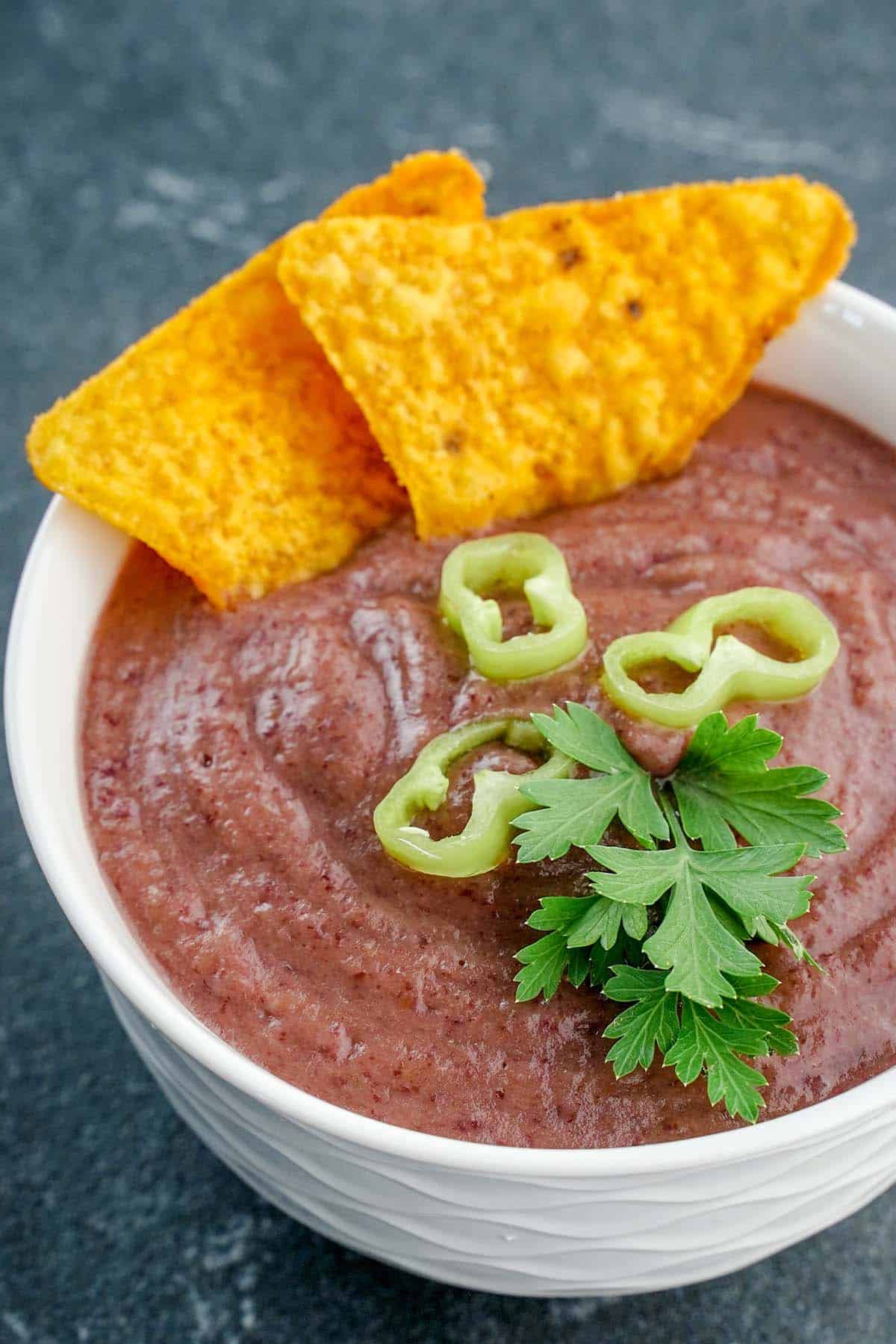 up-close image of bean dip with chips