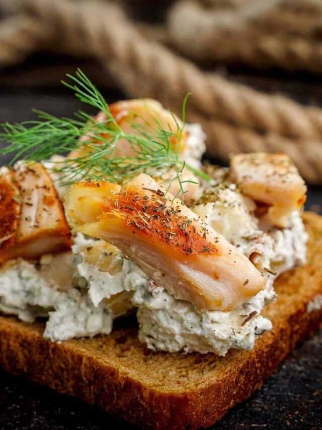 Chicken Blue Cheese and Walnut Sandwiches, close up with sprig of dill on top.