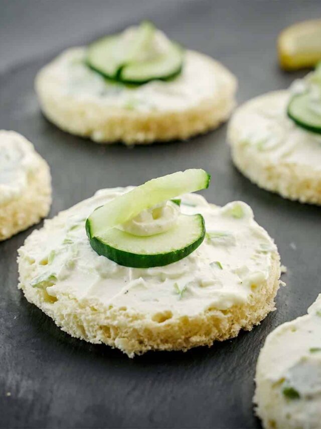 Cucumber Sandwiches, close up on black slate.