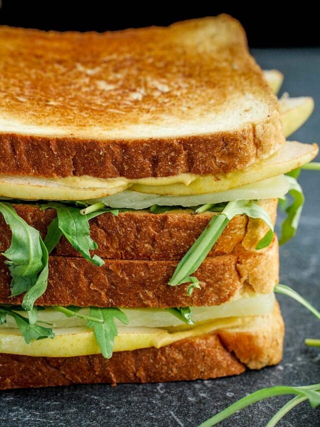 Close up of Pear Gouda Grilled Cheese. stacked by two.