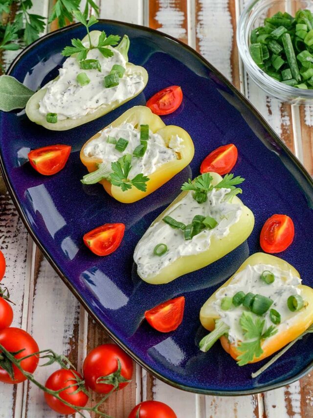 cheese stuffed baby peppers on a serving dish