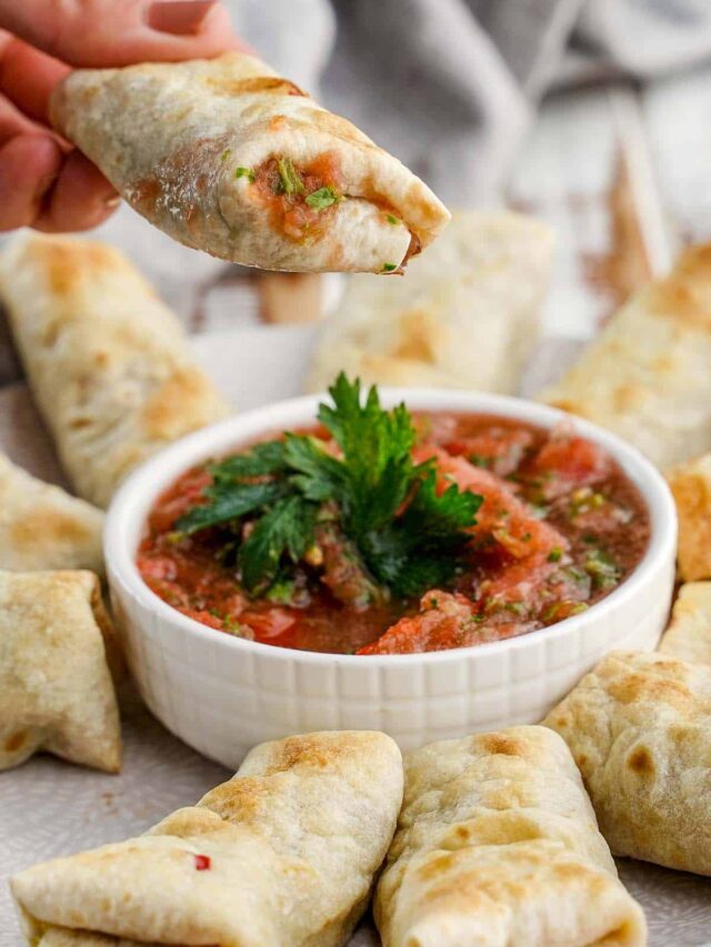 mini burritos and salsa on a plate