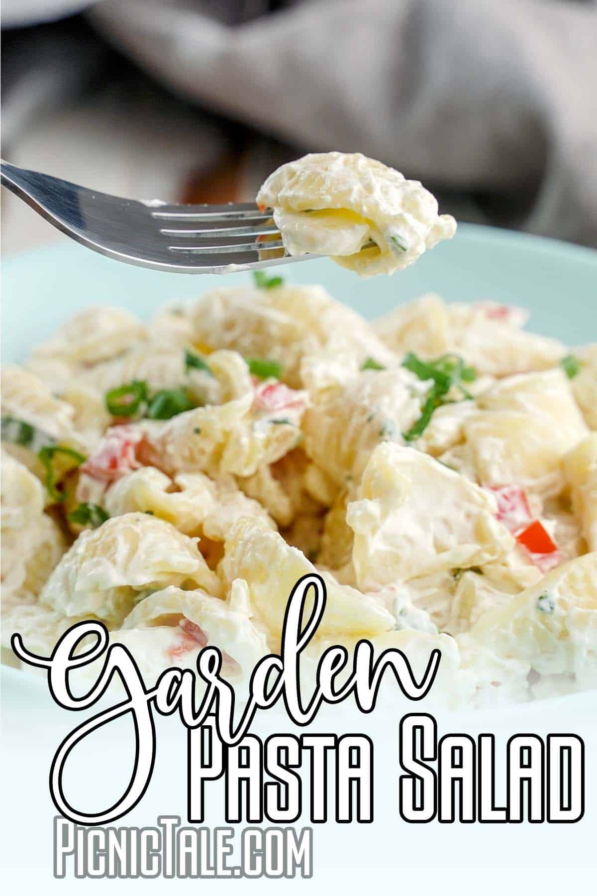 forkful of fresh vegetable pasta salad with text which reads garden pasta salad