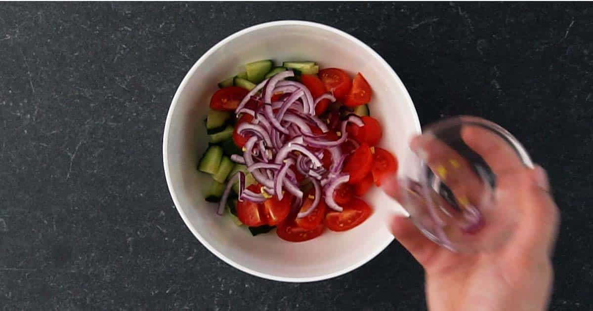mixing veggies for Greek Salad pockets.