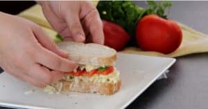 layering ingredients to make a grille cheese sandwich with tomatoes