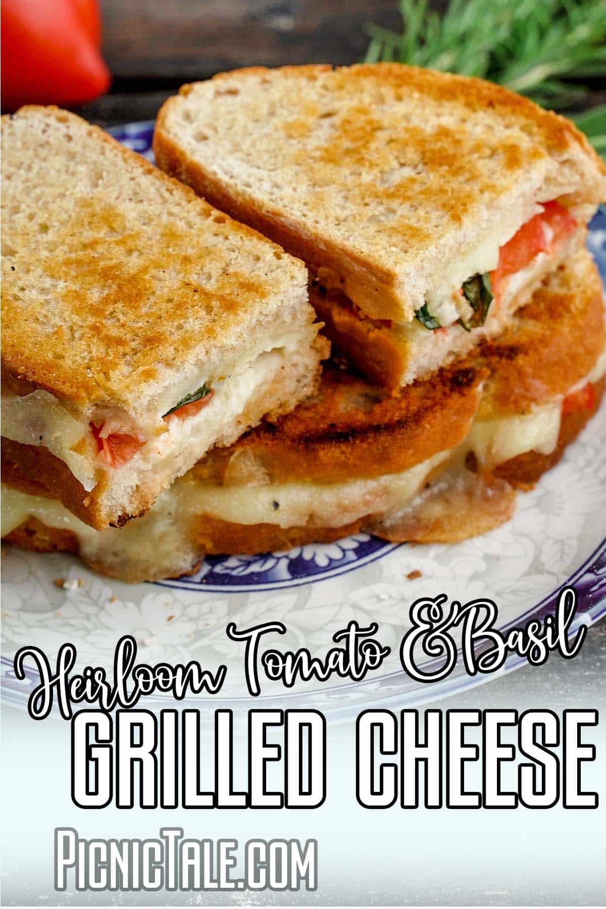 closeup of a picnic sandwich with text which reads heirloom tomato and basil grilled cheese sandwich