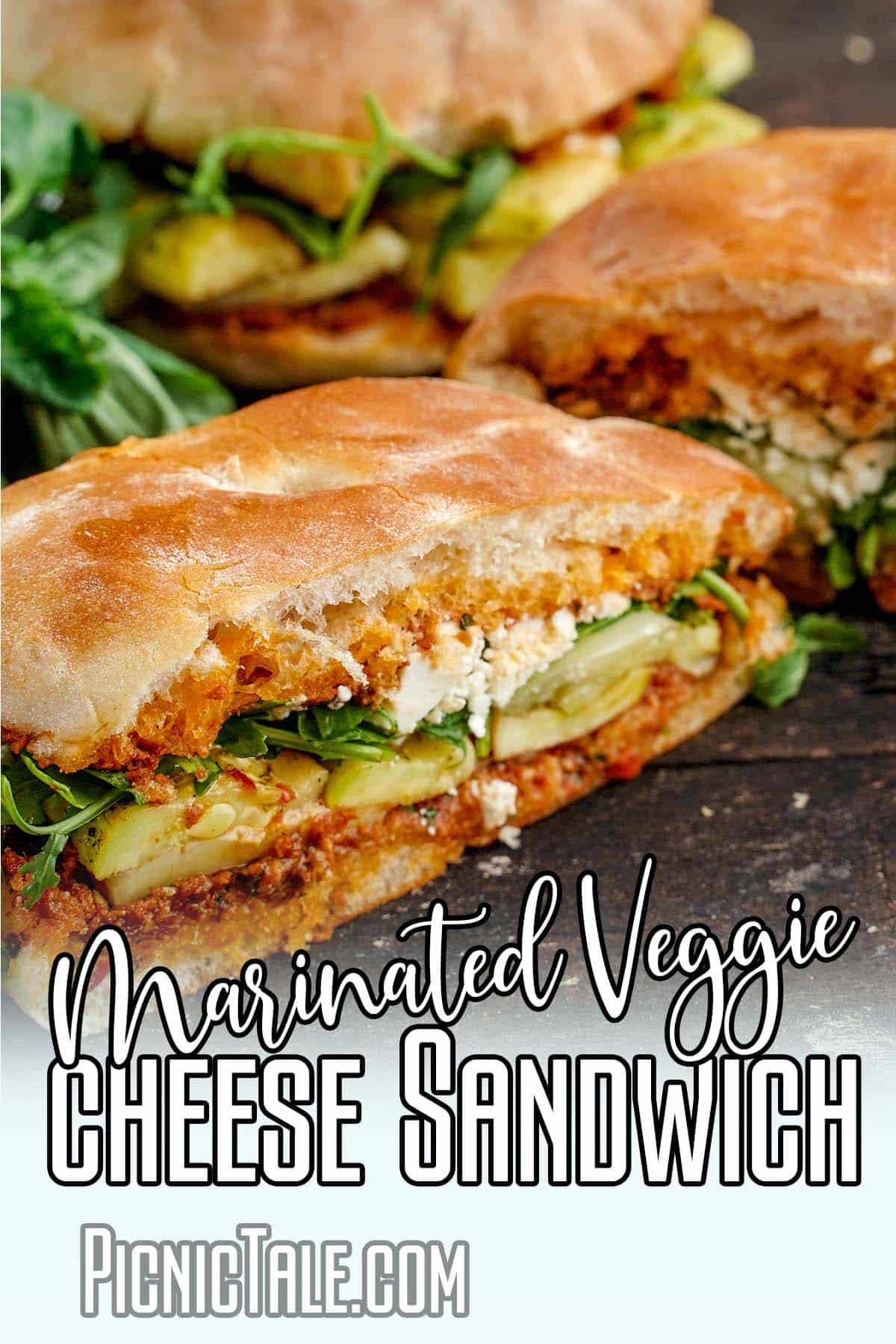 Marinated veggie cheese sandwich, cut wording on bottom.