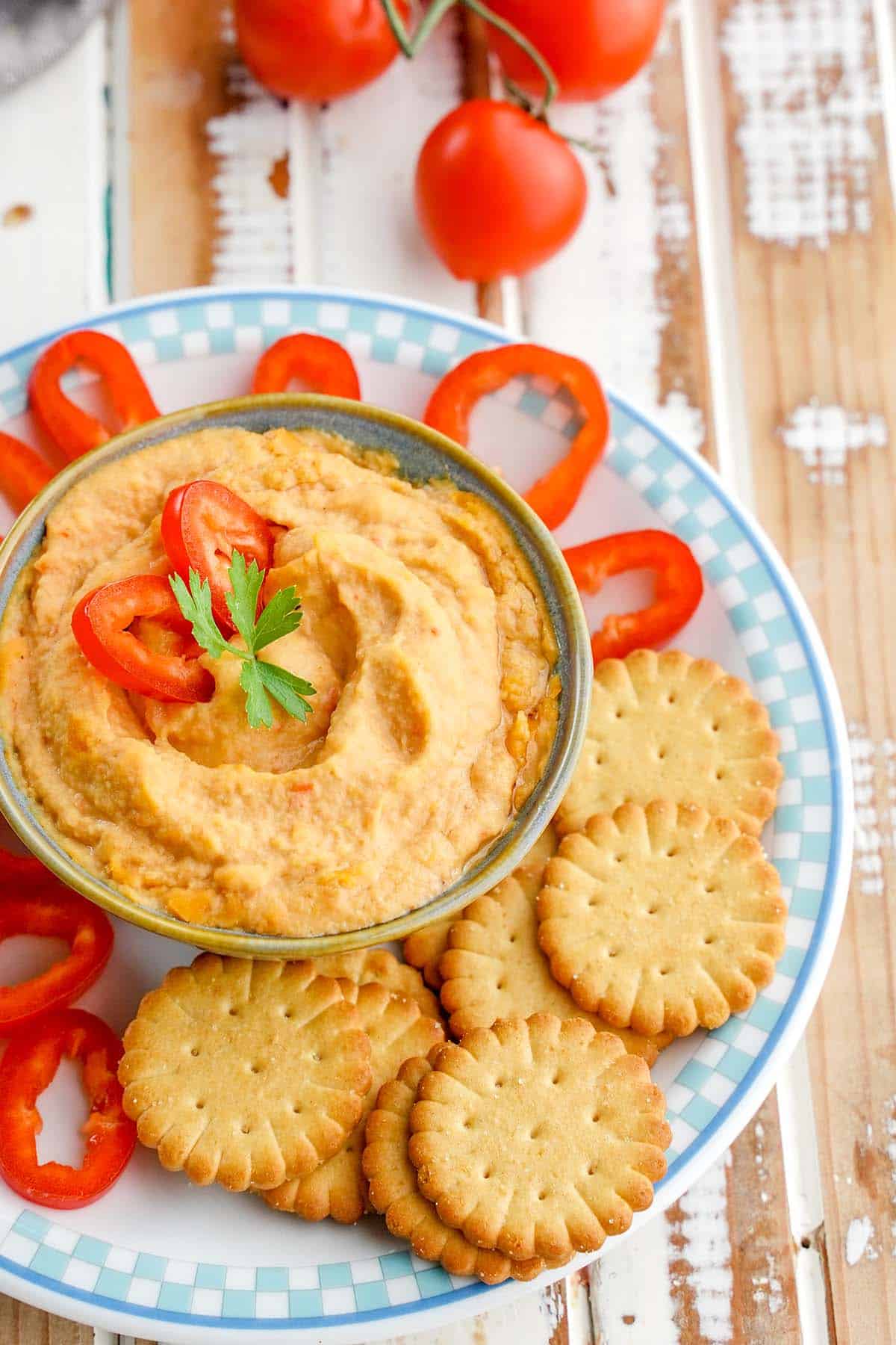 plate of roasted red pepper hummus for a picnic