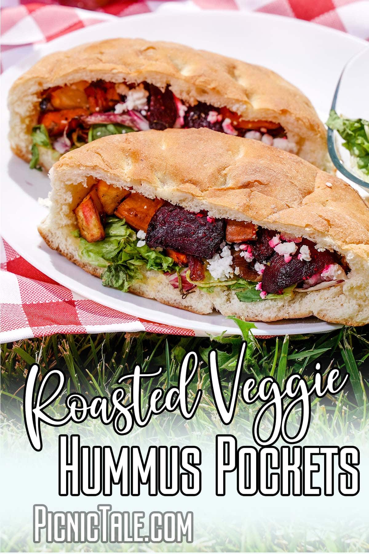 closeup of a picnic sandwich with text which reads roasted veggie hummus pockets