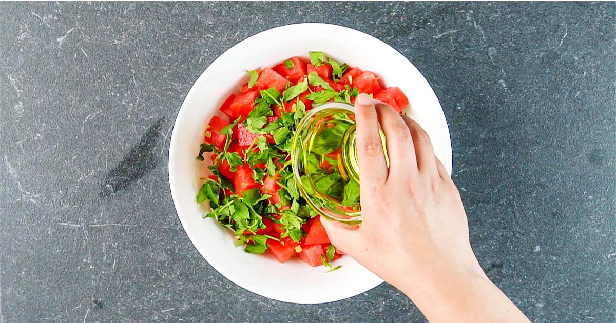 combining watermelon and mint to make a salad