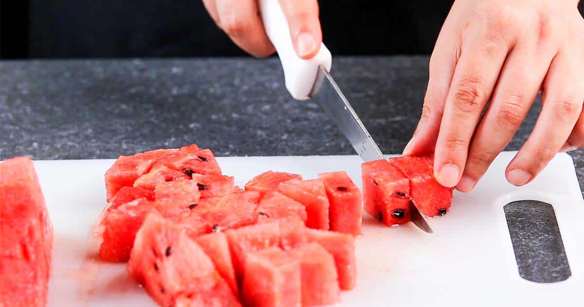 cutting up watermelon for a salad